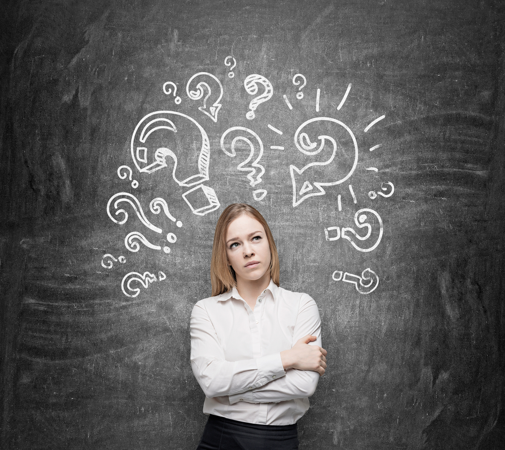 Young,Woman,With,Hands,Crossed,Looking,Up,,White,Painted,Question