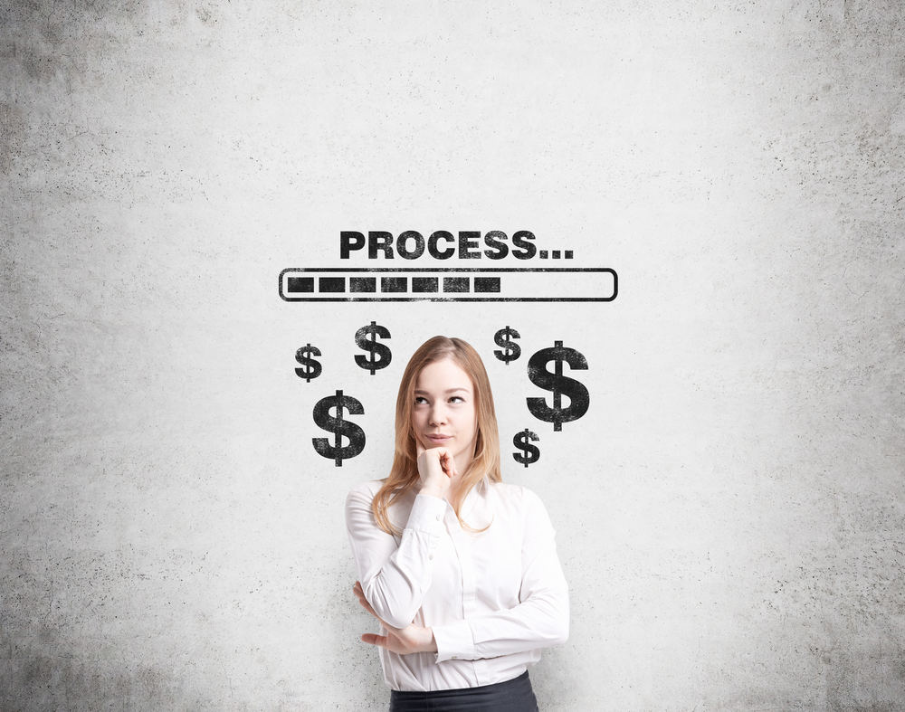 A,Young,Pretty,Businesswoman,With,Hand,To,The,Chin,Thinking